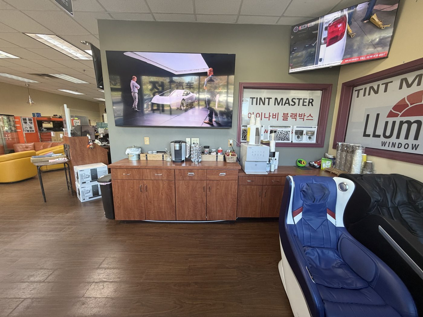 Free coffee and drinks station next to a massage chair and TVs